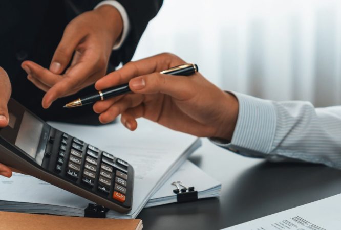 Auditor and accountant team working in office, analyze financial data and accounting record with calculator. Accounting company provide finance and taxation planning for profitable cash flow. Insight