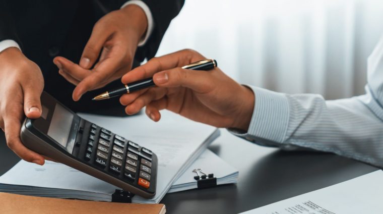 Auditor and accountant team working in office, analyze financial data and accounting record with calculator. Accounting company provide finance and taxation planning for profitable cash flow. Insight