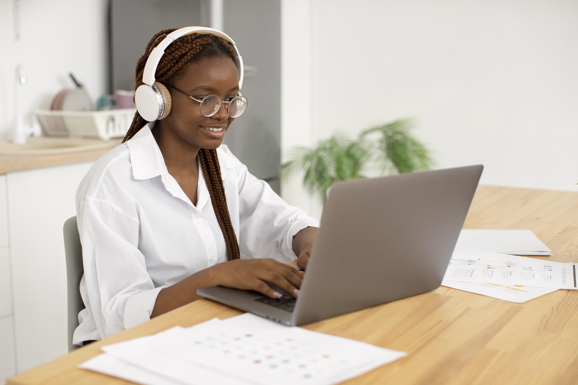 young-woman-working-with-her-headphones young-woman-working-with-her-headphones